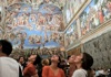 A group of tourists nside the Sistine Chapel