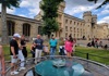 A group of tourists standing at the Anne Boylen execution site in the Tower of London with their guide from The Tour Guy.