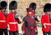 An image of a group of British Royal Guards walking through the Tower of London.