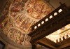 A frescoed ceiling inside a grand basilica, showcasing vibrant artwork and intricate architectural details.