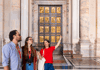 Two tourists looking at the Holy Door inside of St. Peter's Basilica in Vatican City, Italy  while on tour with The Tour Guy. 