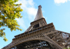 A tourist on a Seine River Cruise near the Eiffel Tower with their guide from The Tour Guy.