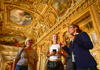 Tourists in front of the Mona Lisa having their picture taken.
