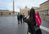 A picture of tourists getting a photo in front of St. Peter's Basilica in Vatican City while on tour with The Tour Guy. 