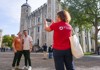 A pair of tourists having their picture taken in the Tower of London by their guide from The Tour Guy.