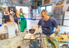 Tourists on Murano Island watching a glassblowing demonstration.