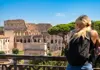 A woman looking at the Colosseum.