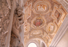 A woman taking a picture of the Golden Staircase inside the Doge's Palace.