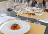 An image of fresh pasta and a flight of Tuscan wines.