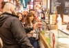 Guide pointing at food stalls inside Sant'Ambrogio Market