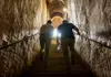 Visitors climbing stone stairs exiting the Roman catacombs
