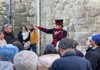 A Tower of London Beefeater speaking with a group of visitors on tour with The Tour Guy.