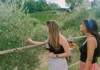 A couple of tourists walking through a vineyard while on tour with The Tour Guy.