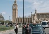 A traditional London Black Cab parked in front of Big Ben.