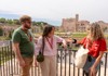 Two tourists looking out to the Roman Forum while listening to their guide from The Tour Guy.