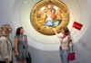 Tourists looking at the Holy Family painting at the Uffizi Gallery while on tour with The Tour Guy.