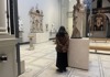 A tourist looking at the exhibitions inside of the V&A Museum in London while on tour with The Tour Guy. 