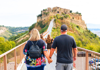 Couple walking on the bridge toward Civita di Bagnoregio