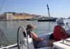 Guests relaxing on a sailboat near Praça do Comércio