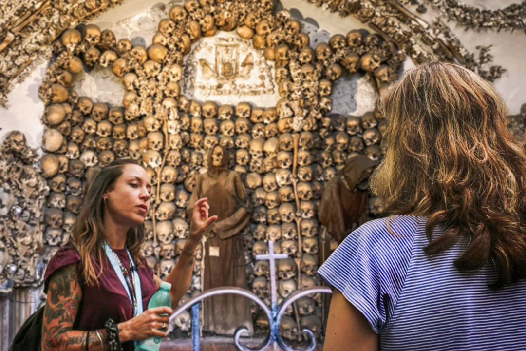 A group of tourists inside the catacombs in Rome with a guide from The Tour Guy.