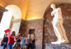 Tourists learning about the Venus de Milo inside the Louvre Museum with their guide from The Tour Guy.