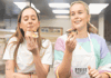 Two girls eating donuts while on a baking tour in London with The Tour Guy.