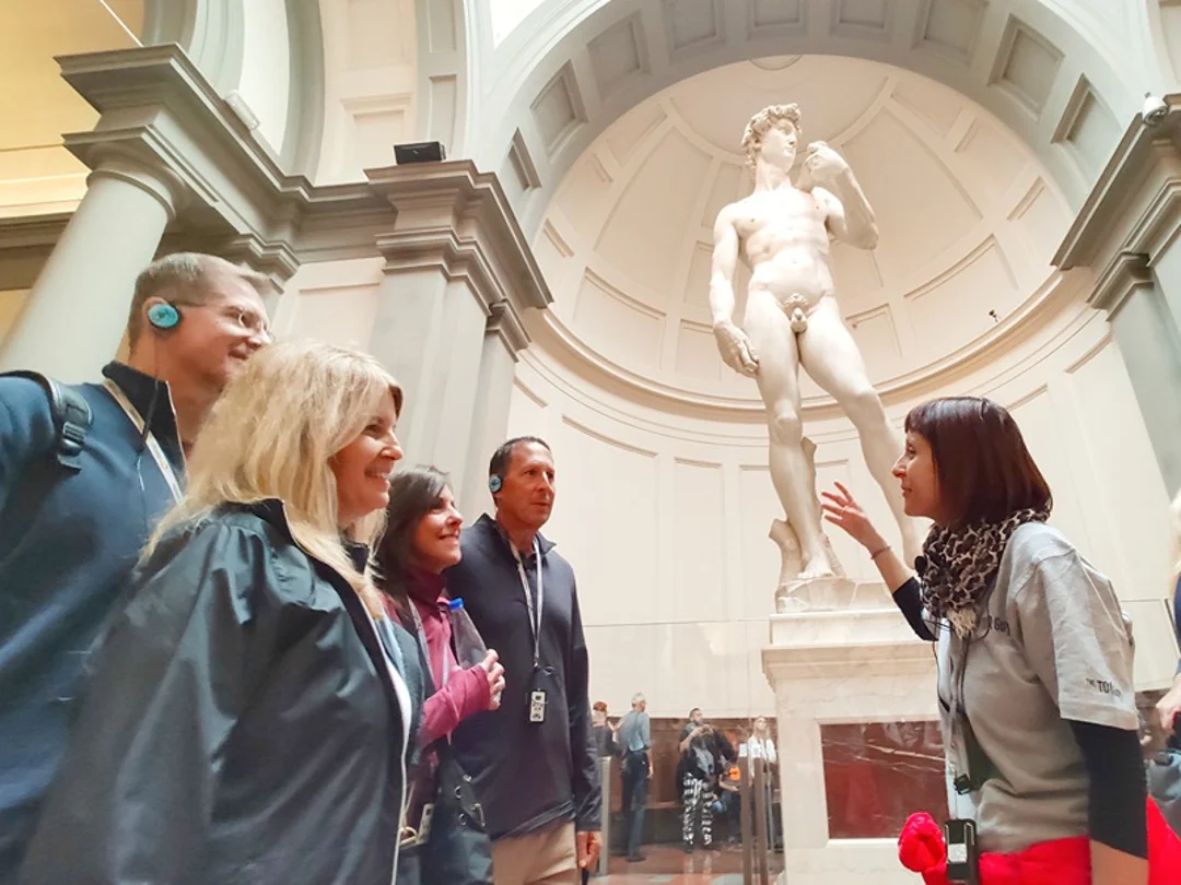 Accademia david A group of tourists in front of the Statue of David while listening to their guide from The Tour Guy.