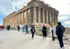 people standing near parthenon under construction