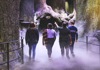 Four kids walking across a reproduction of the Forbidden Forest among the fog.