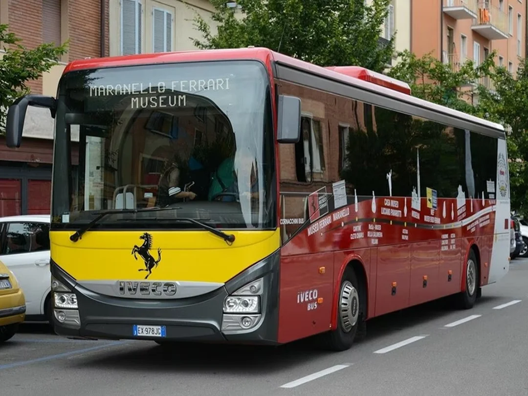 Ferrari Museum shuttle bus driving through a residential street in Modena
