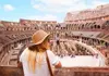 A group of tourists at the Colosseum with their guide from The Tour Guy.
