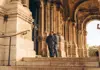Visitors exploring the stone arches of a historic building in Paris