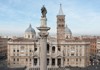The grand façade of the Basilica of Santa Maria Maggiore in Rome, with its twin bell towers standing against a clear sky.