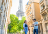 A tour guide standing in front of the Eiffel Tower in Paris.