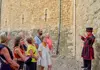 A Tower of London Beefeater speaking with a group of visitors on tour with The Tour Guy.