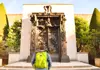 A man looking at the Gates of Hell at the Rodin Museum in Paris.