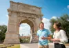 Guide speaking with guests near the Arch of Titus in the Roman Forum