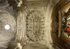 Carved stone ceiling inside Seville Cathedral, filled with sculpted biblical figures and decorative reliefs.
