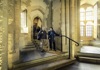 A group of tourists walking inside the Tower of London.