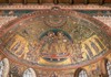 A close-up of a richly detailed mosaic inside a historic church, depicting religious figures in gold and vibrant colors.