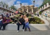 Two tourists taking a picture inside of Park Guell in Barcelona. 