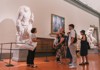 A group of tourists walking through the Accademia Gallery while on tour with The Tour Guy.