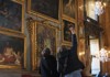 A picture of two tourists pointing at artwork inside of Palazzo Colonna in Italy. 