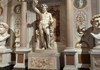 An image of the statue Colossal Statue of Dionysus inside the Borghese Gallery.