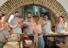 A group of people in aprons preparing food