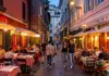 A group of tourists eating pasta in a restaurant in Rome.