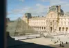 Louvre Museum courtyard and glass pyramid under a blue sky in Paris