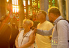 A pair of tourists inside the Sagrada Familia during Golden Hour listening to their guide from The Tour Guy.