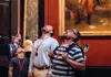 a group of tourists admiring the jaw-dropping details at the Louvre Museum halls