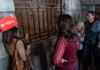 A group of tourists in the Doge's Palace dungeon listening to their guide from The Tour Guy.